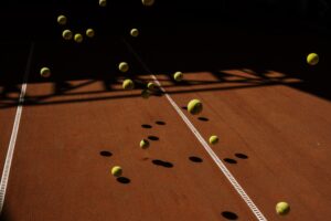 Multiple tennis balls in motion on a tennis court, symbolizing the concept of Bounce Rate in web analytics.