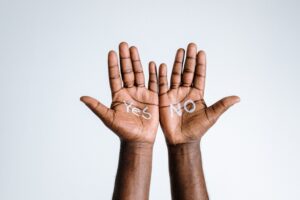 Image of two arms extended with palms up, the left palm has the word 'yes' written on it and the right palm has the word 'no' written on it, symbolizing a choice or decision. Specifically, the process of A/B testing.