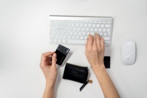 A person using a laptop for online shopping, with a credit card in hand, indicating a digital purchase or transaction resulting from a call to action.