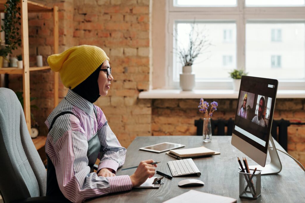 Sales Development Representative (SDR) passionately engaged in a video call on her computer, illustrating the modern approach to SDR prospecting through online communication and lead generation.